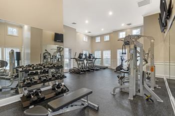 A spacious home gym with a variety of exercise equipment.